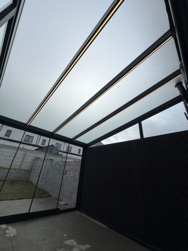 LED strips built into the roof beams of a pergola veranda